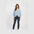 Sky blue open-front crochet cardigan with white granny-stripe trim and three-quarter balloon sleeves, worn over a grey tee.
