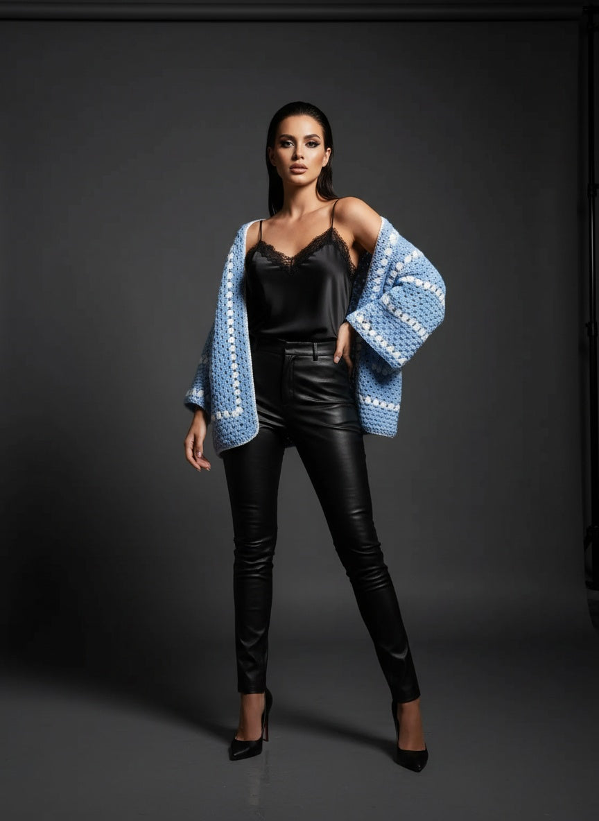Model wearing the Sky Blue Granny-Stripe Crochet Cardigan styled with black satin and leather