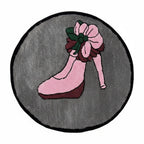 Retro pin-up tufted rug on a white background: round grey rug with a leg in a pink high heel and a pink rose at the ankle, bound in black.